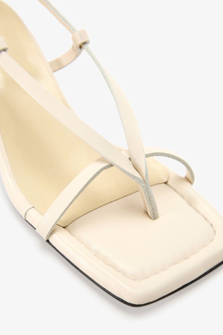 Strappy sophistication. Our Greta Sandals feature a modern square toe and an adjustable slingback strap for a flattering look, enhanced by a chic kitten heel and minimalist raw edges. Whether it's running between meetings or dancing the night away, their padded soles and soft Italian leather let you do it all in comfort—and impeccable style.[SPLIT] Astrid wears Greta in cream, in disco, and in black. Heel height is approximately 2" (5 cm). Sold in US sizes, though please note that shoes may be l Black Heel, Social Impact, Modern Square, Work Week, The A Team, Kitten Heel, Health Insurance, Italian Leather, Leather Sandals