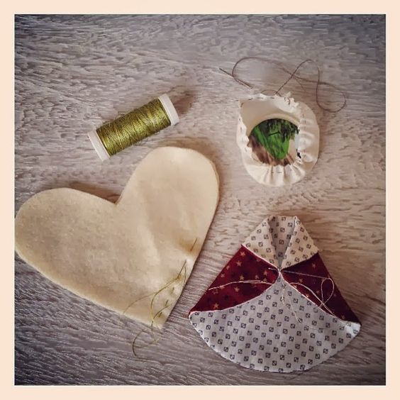 three pieces of fabric are laid out on a table next to thread and spools