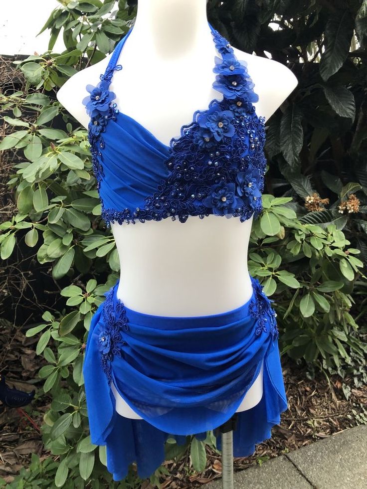 a mannequin wearing a blue dress with sequins on the top and bottom