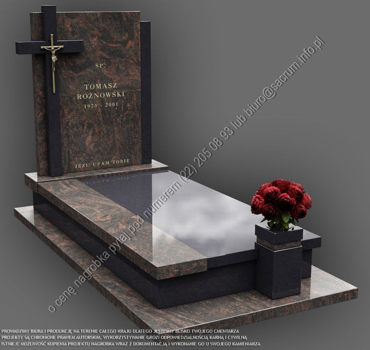 a memorial with a cross on top and a red rose in a vase next to it