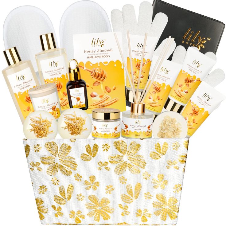 an assortment of skin care products displayed in a white and gold gift basket with flowers