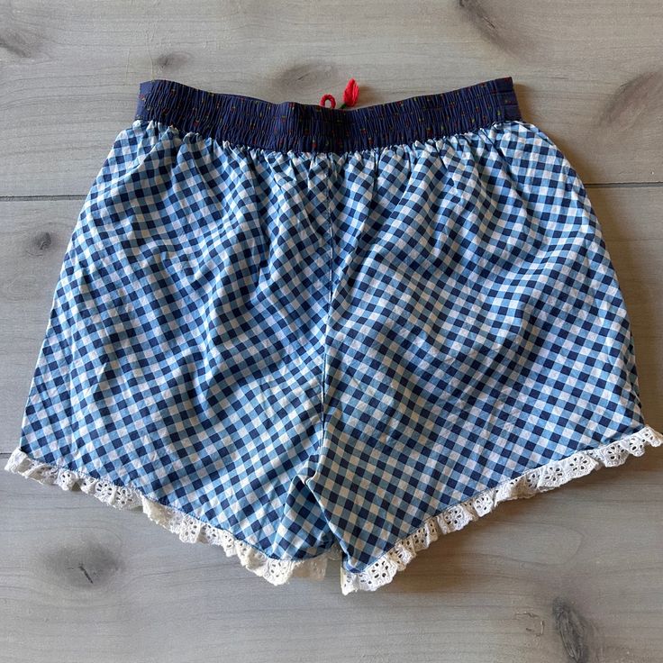 Matilda Jane Plaid Ruffle Shorts with Cheeries Pull on blue and white plaid ruffle shorts with cheeries around the waistline. Size 14 years. 100% cotton. Excellent used condition Gingham Cotton Shorts For Daywear, Cotton Gingham Pajama Shorts With Elastic Waistband, Cotton Bottoms For Picnic, Short Length, Cotton Bottoms For Picnic In Short Length, Plaid Cotton Shorts For Daywear, Cotton Shorts For Picnic, Blue Cotton Bloomers With Ruffles, Gingham Pajama Shorts With Elastic Waistband, Cotton Ruffled Bottoms For School