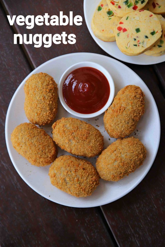 some food is on a white plate with ketchup and sauces next to it