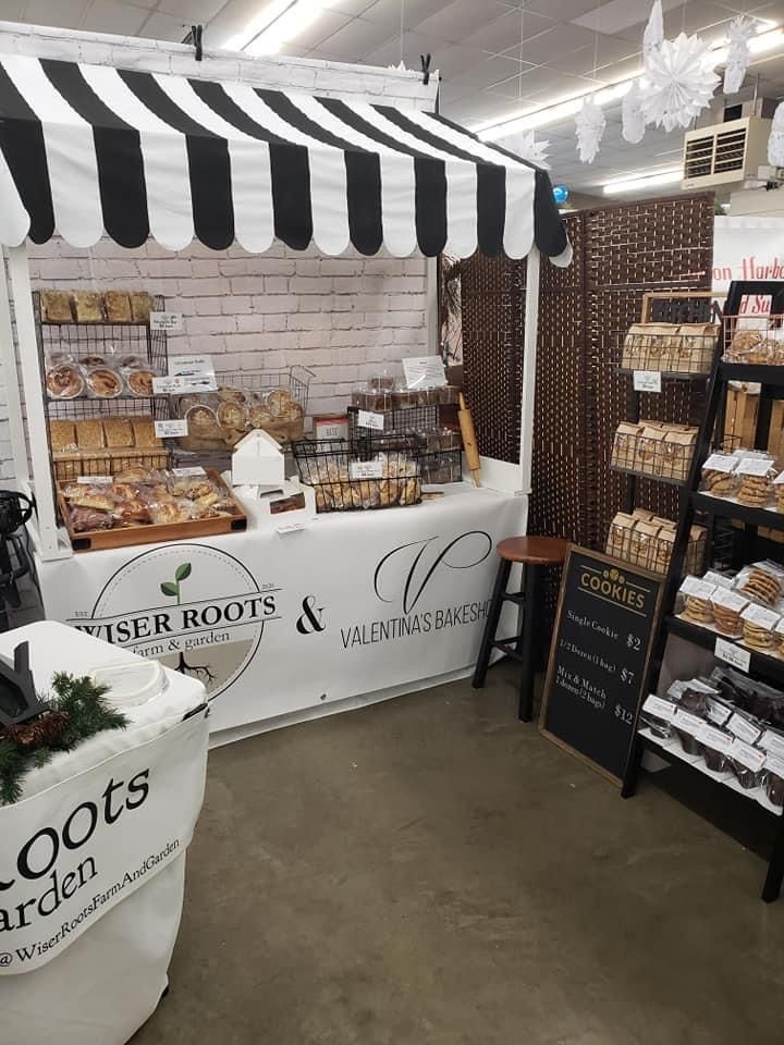 the inside of a store with an assortment of baked goods on display and in front of it