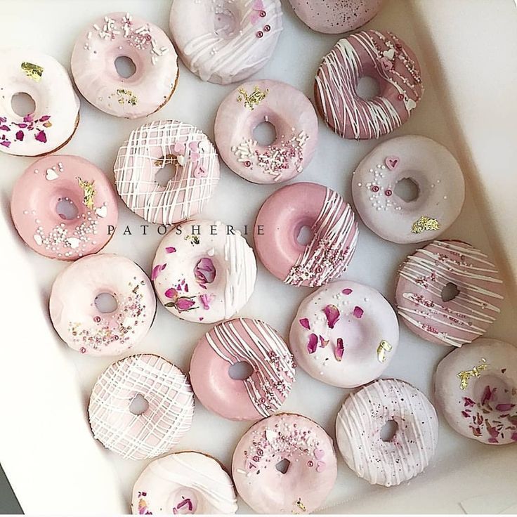 a box filled with lots of pink and white donuts