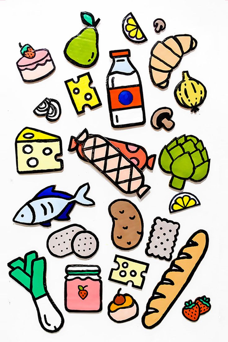 an assortment of food stickers sitting on top of a white surface