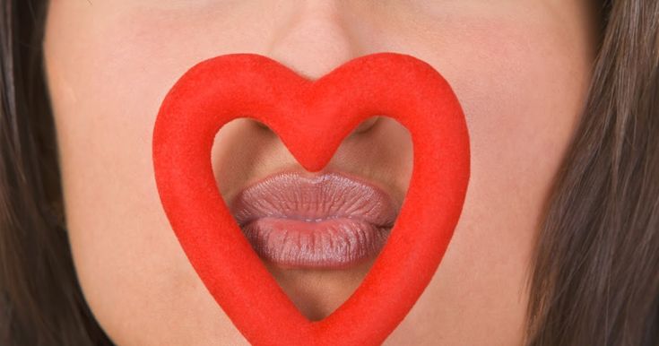 a woman's lips and tongue are shaped like a heart