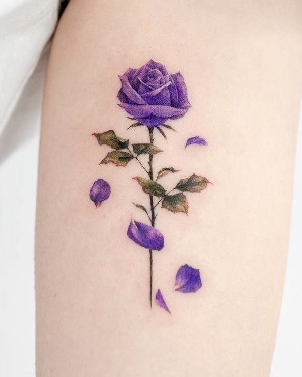 a purple rose tattoo on the right thigh