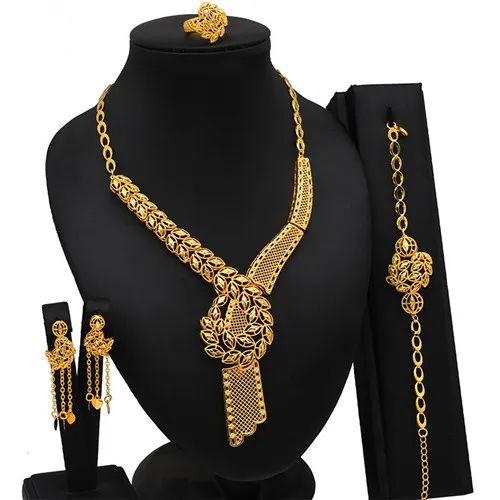 Indulge in luxury with this exquisite Necklace Set, perfect for wedding parties. With its opulent design and superior craftsmanship, this set features a necklace, bracelet, earrings, and ring. Make a lasting impression and elevate your style with this luxurious jewelry set." Luxury Formal Gold Sets, Gold Traditional Jewelry Sets For Formal Occasions, Gold Jewelry With Intricate Design For Formal Occasions, Elegant 22k Gold Jewelry Sets For Gift, 22k Gold Elegant Jewelry, Elegant 22k Gold Jewelry, Gold Plated Bridal Necklace For Formal Occasions, Luxury Gold Jewelry Sets For Weddings, Luxury 22k Gold Jewelry With Elegant Design