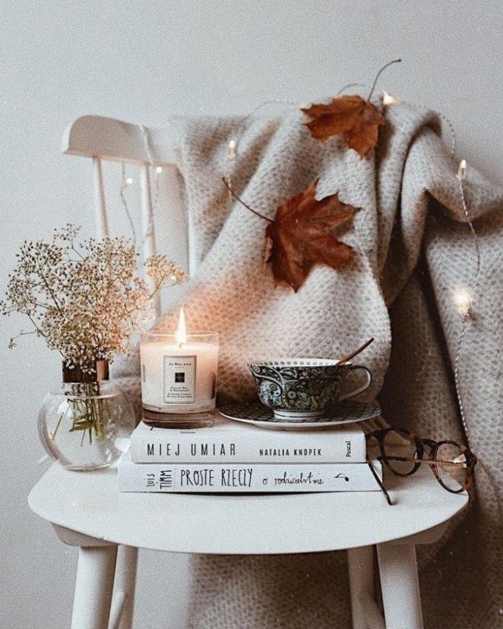 a white table topped with books and candles