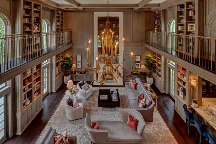 a living room filled with lots of furniture and bookshelves next to each other