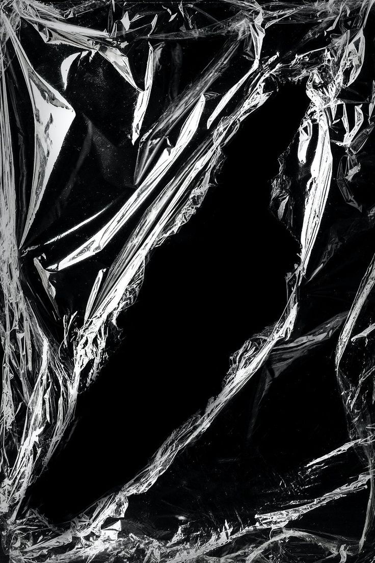 an abstract black and white photograph of plastic wrapper foil covering the surface, with small folds in it