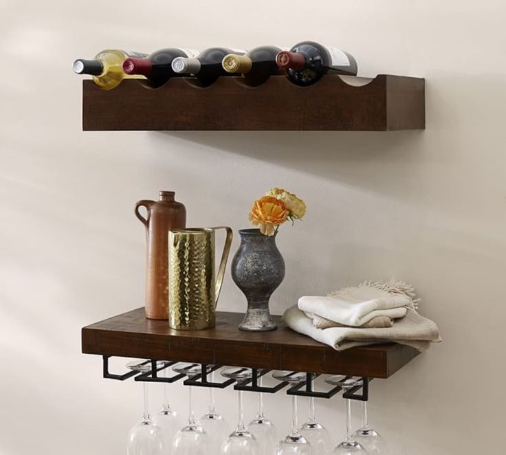 a shelf with wine glasses and bottles on it