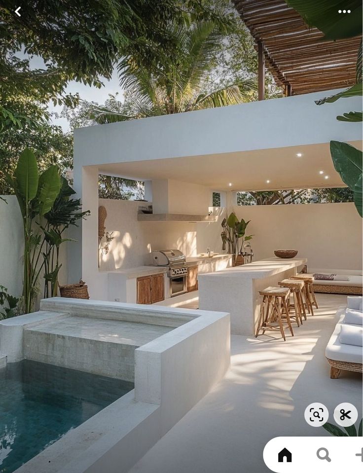 an outdoor kitchen and living room are featured in this instagram photo by the pool