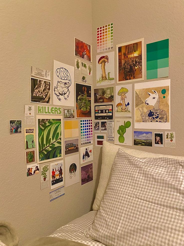 a bed sitting in a bedroom next to a wall covered with pictures and posters on it