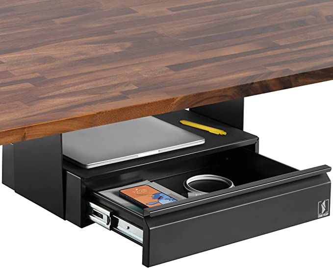 a wooden table with drawers underneath it and a notepad on the bottom drawer next to it