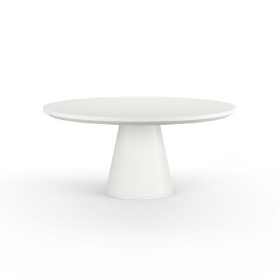 a white table sitting on top of a white floor