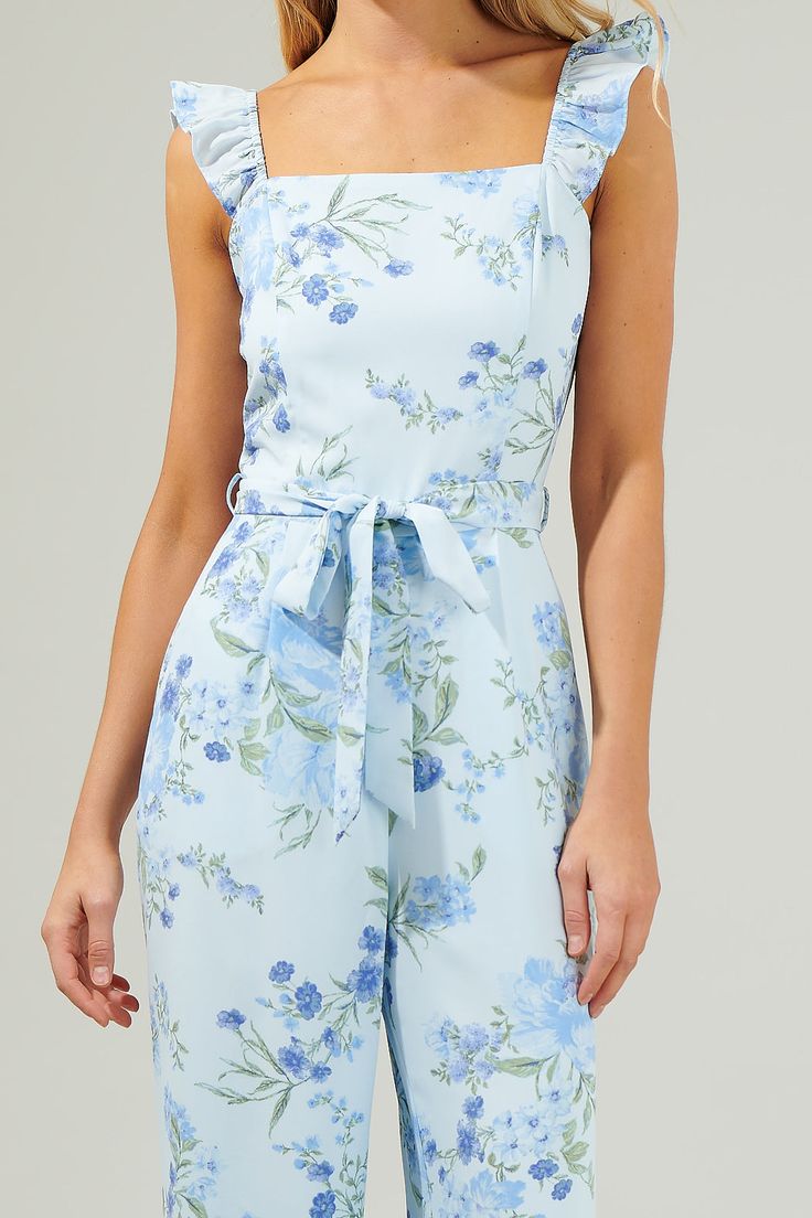 The Dusty Floss Floral Sleeveless Jumpsuit is ready to add a romantic vibe to all your favorite summer outfits! It features a square neckline followed by a sleeveless look with ruffles on the shoulders. It also has a belt tie and straight fit. You will love this jumpsuit! - Square neck- Ruffle- Belted- Smocked- Color: LT BlueSize + Fit - Model is 5'8" and wearing size XS- Measurements taken from size S - Chest: 16 1/2"- Inseam: 32" Fabric Self:100% Polyester Lining:97% Polyester 3% Spandex Style Elegant Spaghetti Strap Jumpsuits And Rompers For Spring, Spring Sleeveless Jumpsuits And Rompers With Tie Straps, Blue Sleeveless Tie Back Jumpsuit, Elegant Sleeveless Summer Jumpsuits And Rompers, Elegant Sleeveless Jumpsuits And Rompers For Summer, Blue Spaghetti Straps Jumpsuits And Rompers, Sleeveless Summer Jumpsuits And Rompers With Tie Straps, Spring Jumpsuits And Rompers With Tie Straps, Elegant Summer Jumpsuits And Rompers With Tie Back