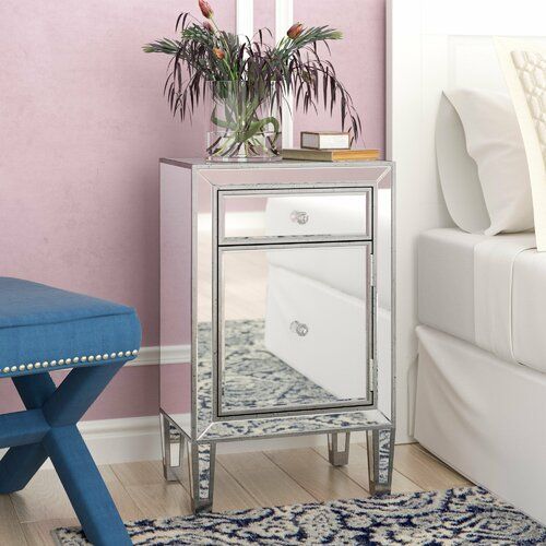 a mirrored cabinet with drawers and a blue bench in front of the mirror on the floor