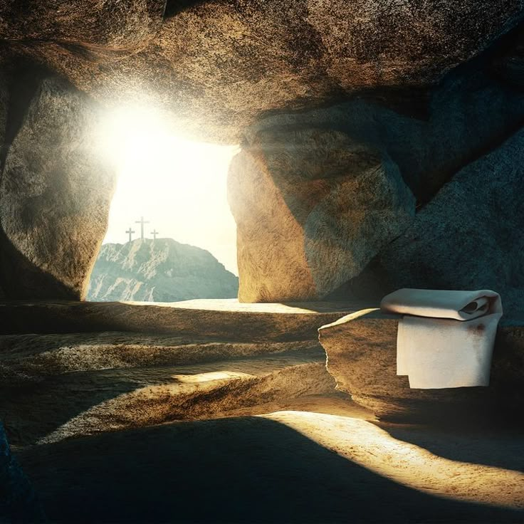 the light shines brightly through an opening in a rock cave with a cross on it