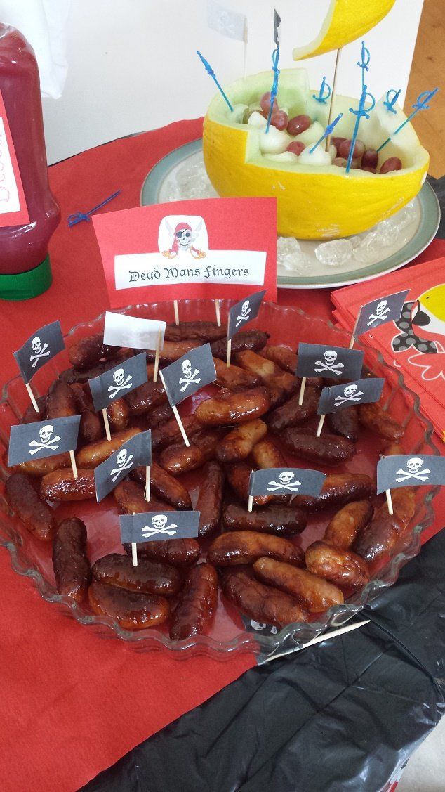 there are many sausages on the table with little flags in front of them for sale