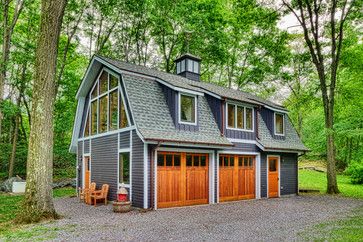 a two car garage in the middle of a wooded area