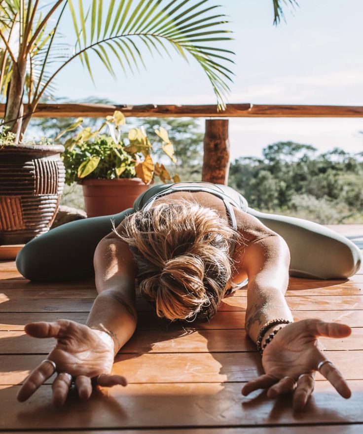 a woman is doing yoga on the deck