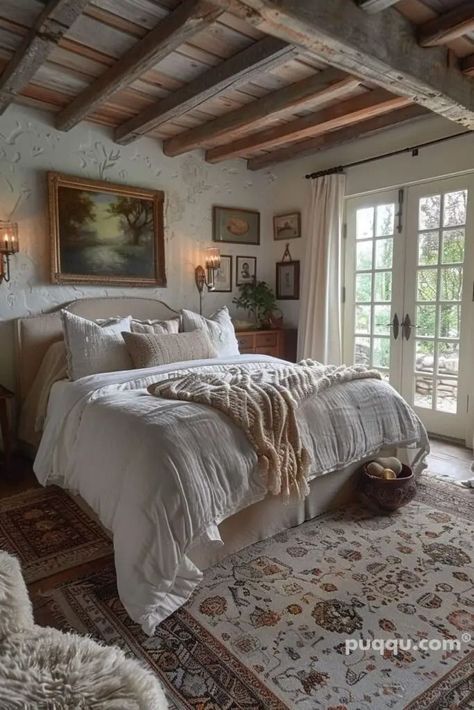 a large bed sitting in a bedroom next to a doorway with french doors and windows