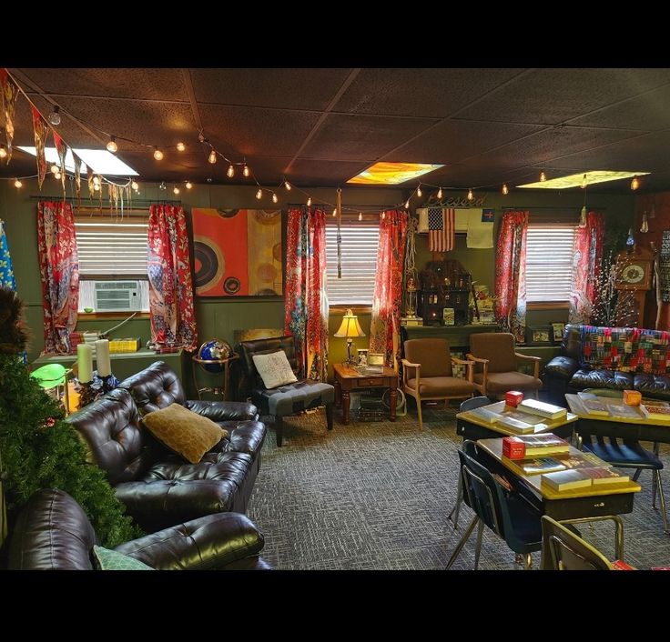 a living room filled with lots of furniture and decor on top of carpeted flooring