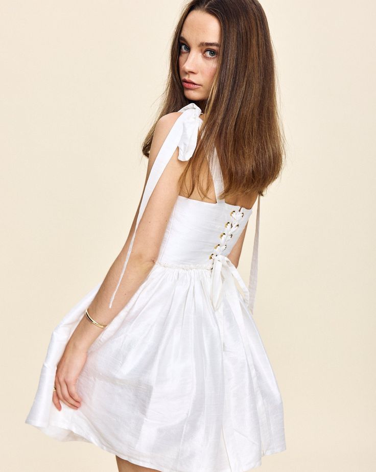 Louise New York creates its collection with the past and present in mind. Inspired by timeless glamour instead of trends, when you slip into a Louise New York dress, you carry all the confidence and carefree attitude that femininity can acclaim. Get best dressed with the Marie Mini Dress in White. This silhouette features a signature corset lace-up back to fit any waist, and boasts a bust with ties at the shoulder for an even more custom fit. Product Details Taffeta. Made in NYC. Care Instructio Timeless Glamour, New York Dress, Corset Lace, Lela Rose, Column Dress, York Dress, Best Dressed, Past And Present, Rose Print