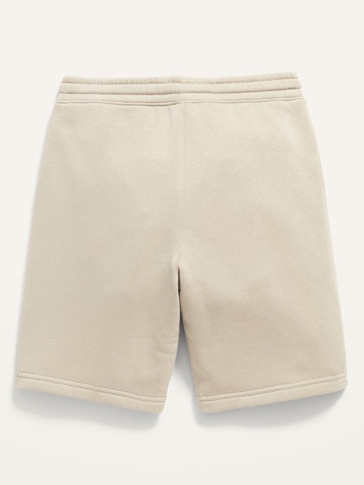 Elasticized waistband, with interior drawstring.  Diagonal front pockets, with jersey lining.  Faux fly.  Soft, garment-washed fleece.  Easy pull-on style.  Sits at waist.  Straight hip and thigh.  Boys jogger shorts hit above knee. Machine wash cold Navy Flats, Boys Joggers, Stones Throw, Jogger Shorts, Fleece Joggers, Above Knee, Old Navy, Short Dresses, Womens Shorts