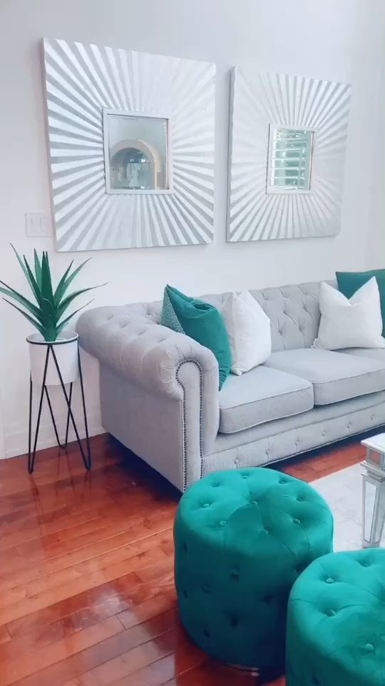 a living room with two couches, chairs and a table in front of them