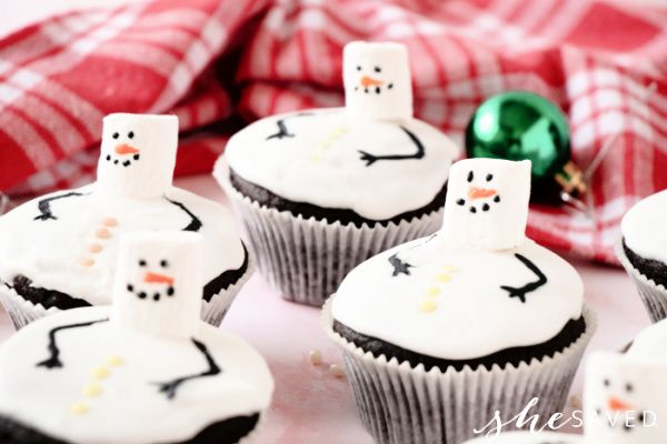 cupcakes with frosting decorated like snowmen