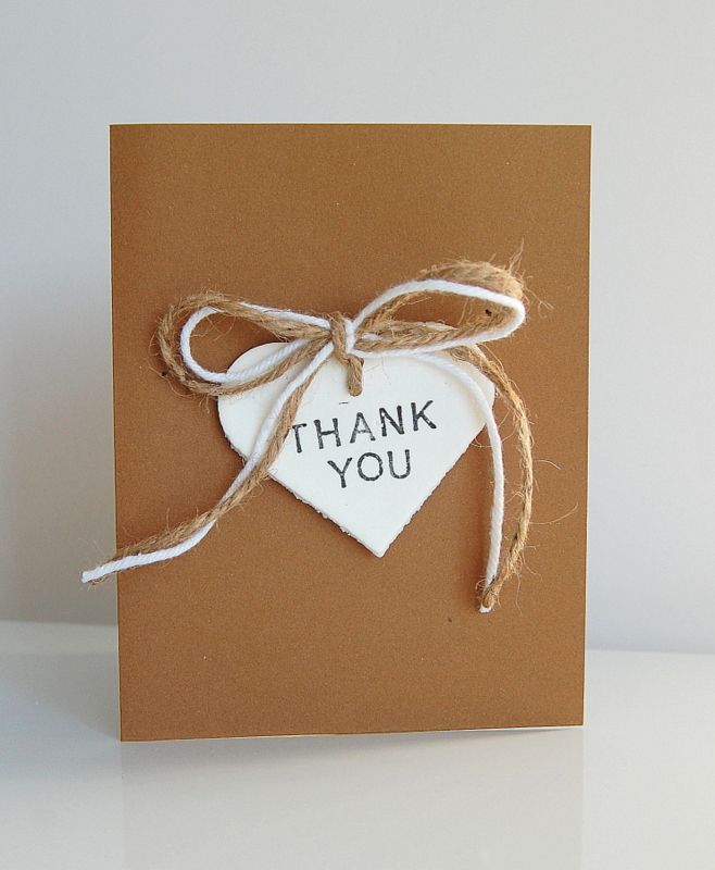 a thank you card with a heart shaped tag tied to the front and back of it