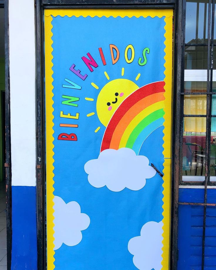 a blue door with a rainbow and clouds painted on the front, behind which is a sign that says blinddoss