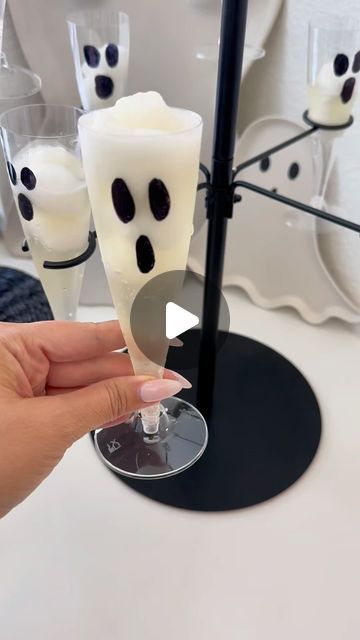 a person holding a glass with some kind of toothpaste in front of them