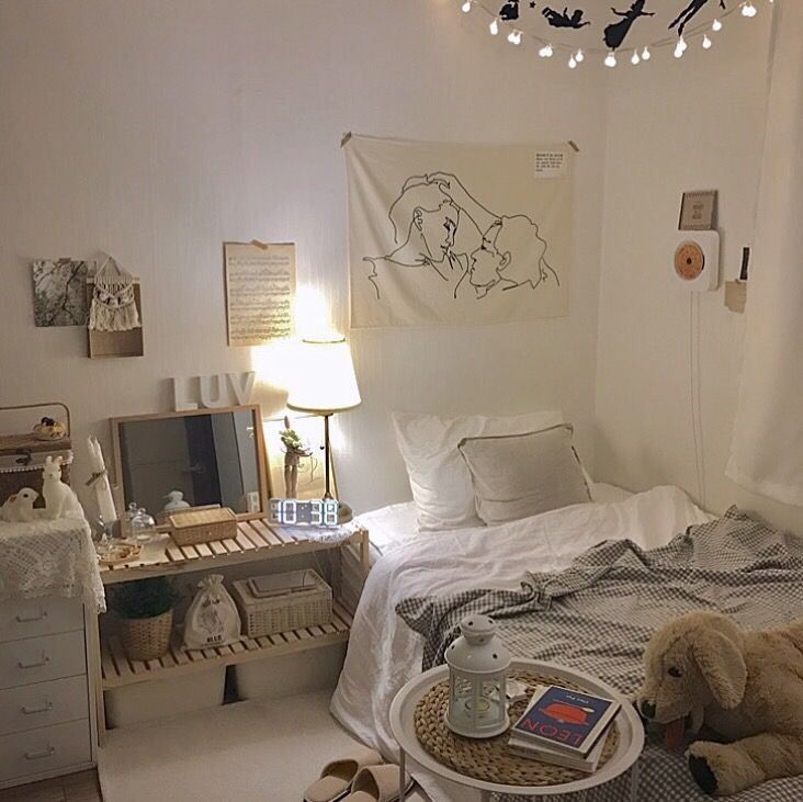 a bed room with a neatly made bed and a teddy bear