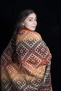 a woman is wrapped in a blanket and posing for the camera