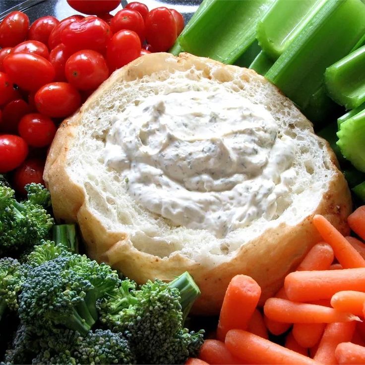 a plate with carrots, celery, broccoli and dip