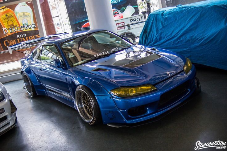 the blue car is parked next to other cars