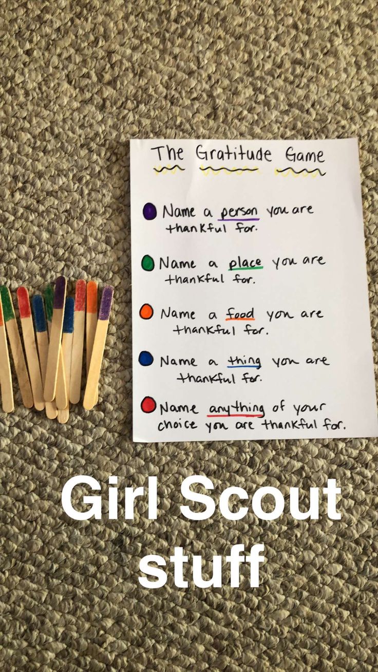 the girl scout stuff is laid out on the floor next to matches and a note