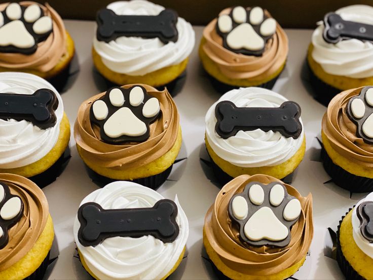 there are many cupcakes with dog paw prints on them