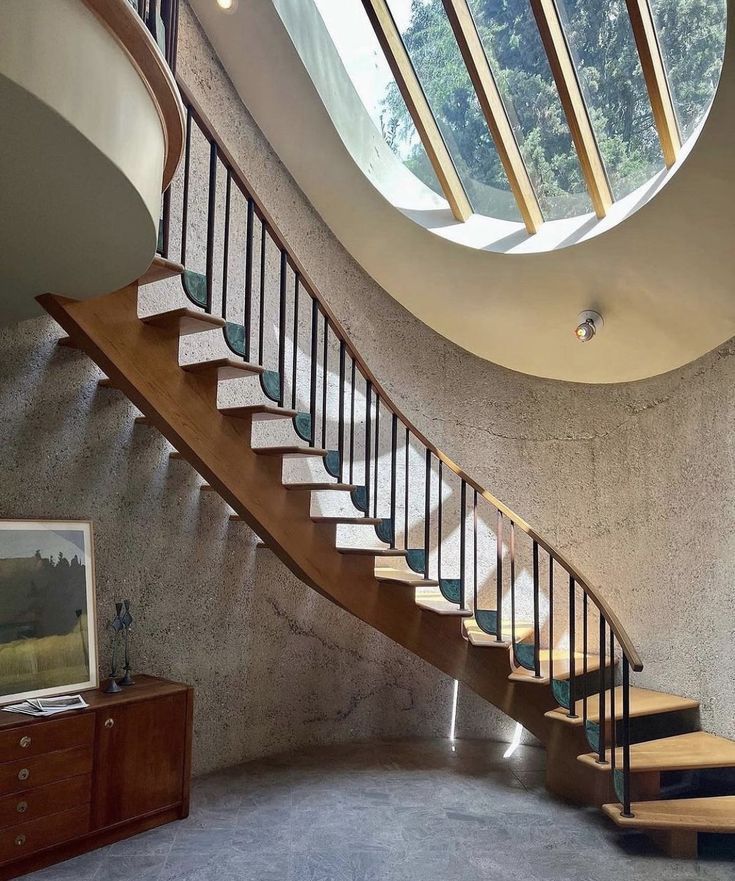 the stairs are made of wood and have skylights above them in this modern home