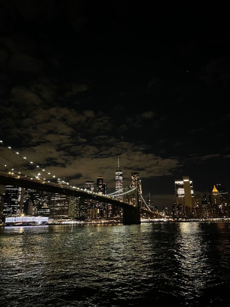 the brooklyn bridge is lit up at night