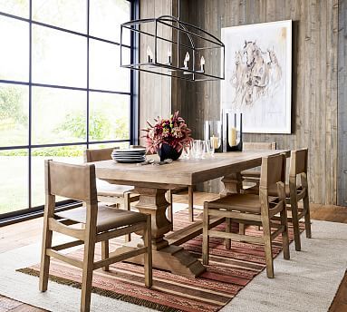 a dining room table and chairs in front of a large window with wood paneling