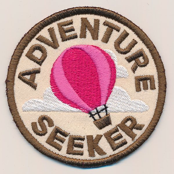 a patch with the words adventure seeker on it and a hot air balloon in the sky