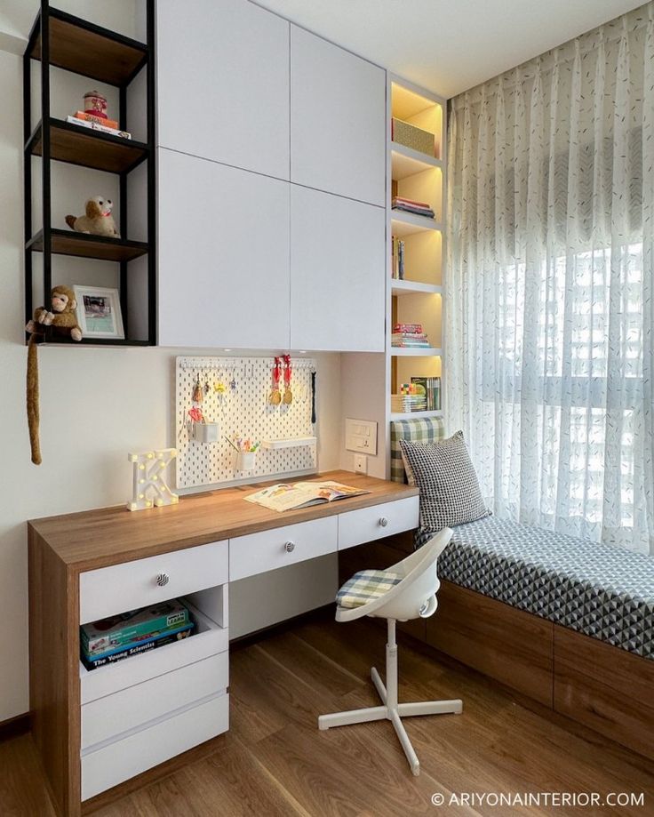 a room with a bed, desk and shelves on the wall next to a window