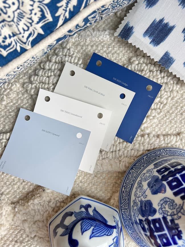 some blue and white plates sitting next to each other on a table with paper tags