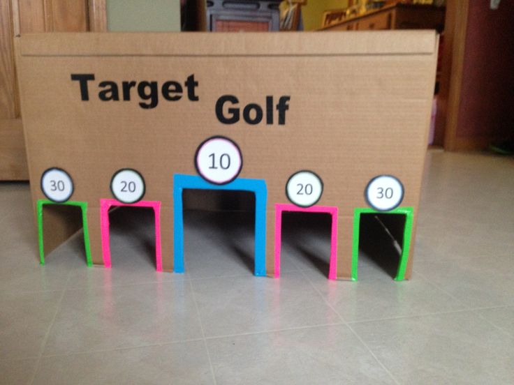 a cardboard target golf game with numbers on the side and numbered blocks in different colors