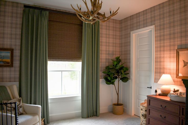 a living room filled with furniture and a lamp next to a window covered in green curtains